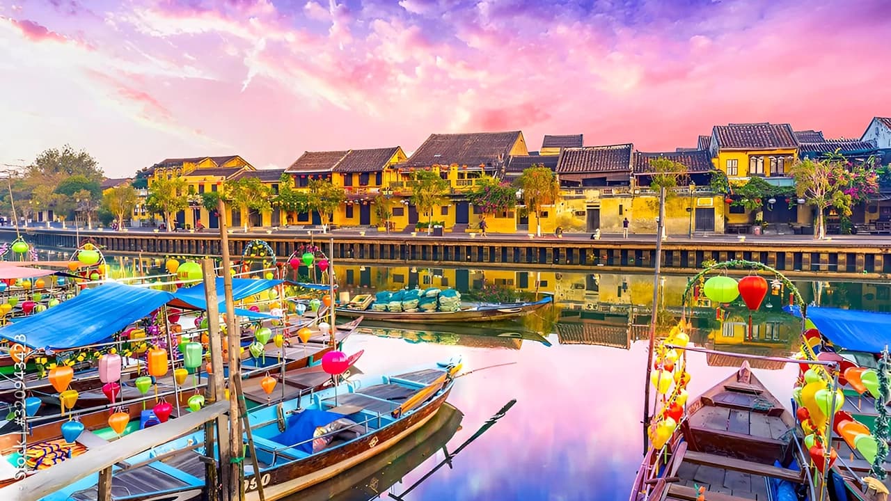 Hoi An riverside at sunset with lanterns and boats